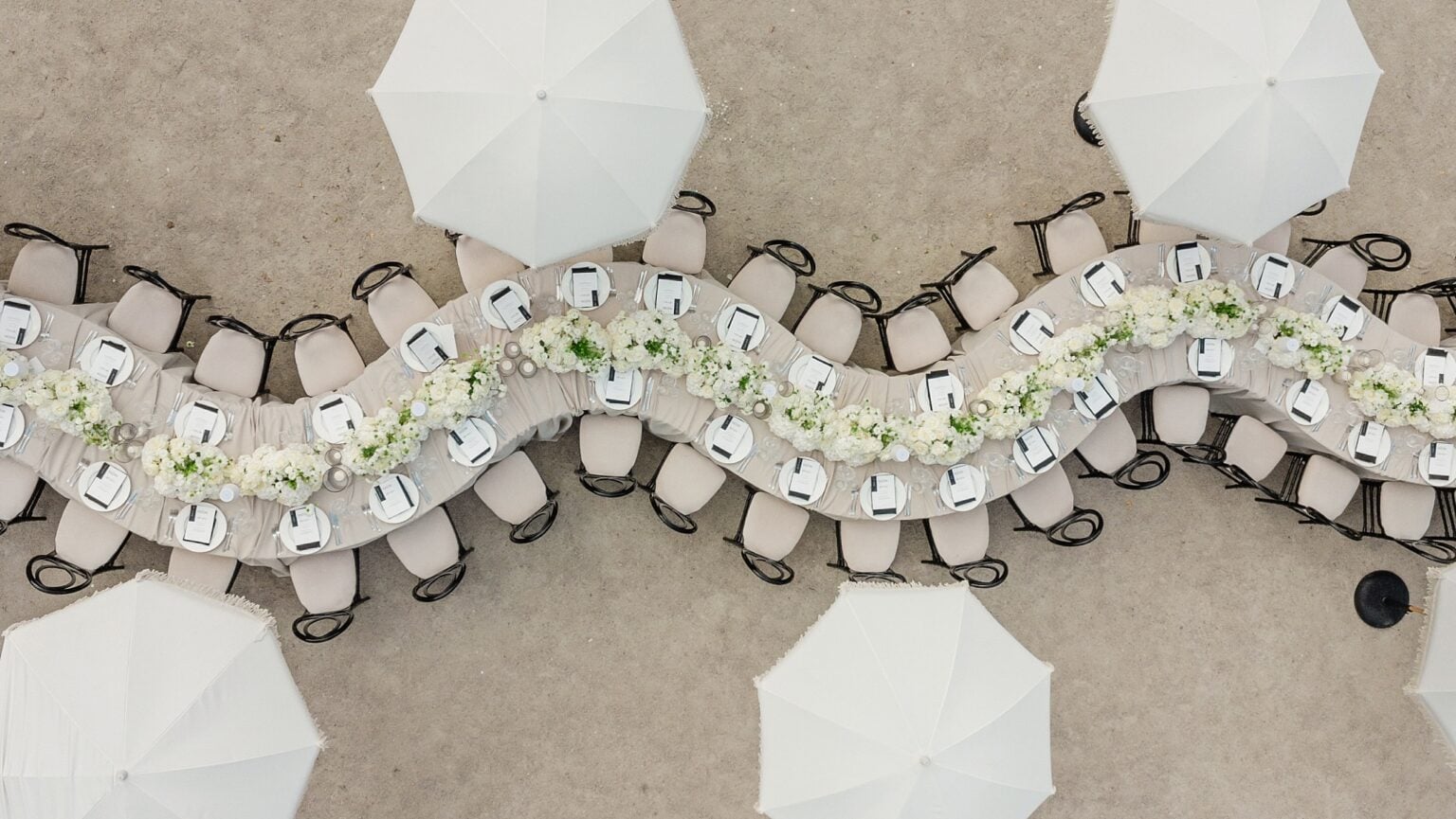 A table with white umbrellas and chairs